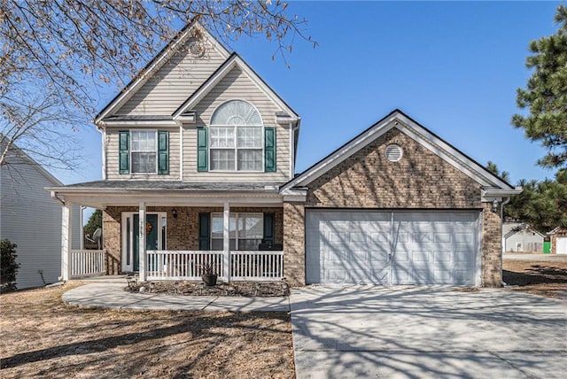 front of property featuring covered porch and a garage