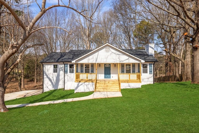 ranch-style house with a front yard and a porch