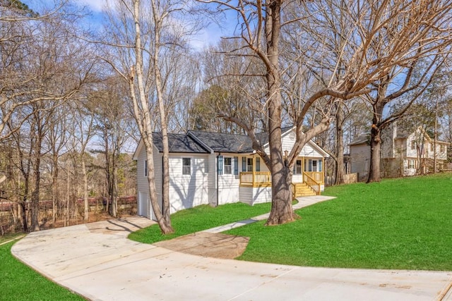 bungalow-style house featuring a garage, covered porch, and a front lawn