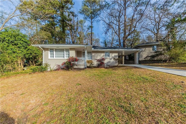 ranch-style home featuring a front yard and a carport