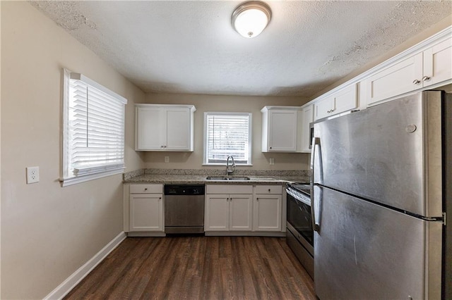 kitchen featuring a textured ceiling, white cabinetry, sink, stainless steel appliances, and dark hardwood / wood-style floors