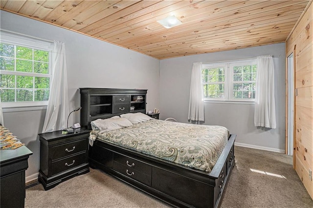 bedroom with baseboards, multiple windows, carpet, and wood ceiling