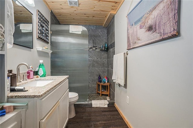 full bathroom with wooden ceiling, tiled shower, vanity, visible vents, and wood finished floors
