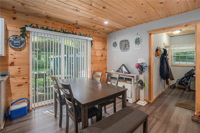 dining space with recessed lighting, wood ceiling, wood walls, dark wood-style flooring, and baseboards