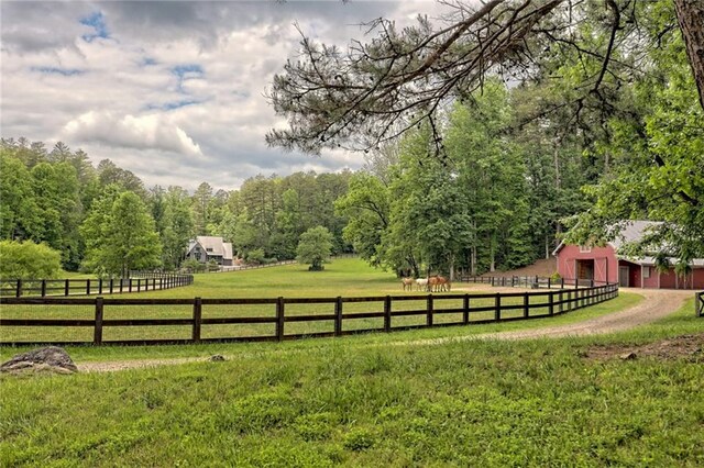 view of yard with a rural view and an outdoor structure