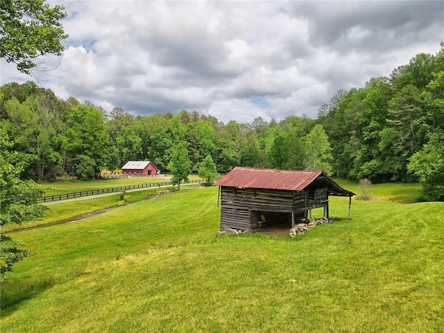 view of yard featuring an outbuilding and a rural view