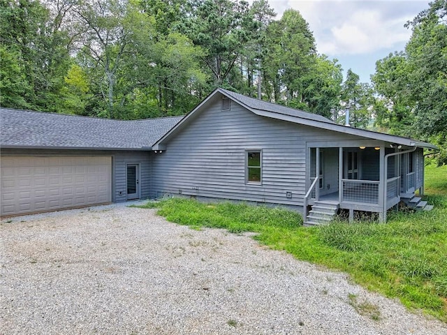 single story home featuring covered porch and a garage