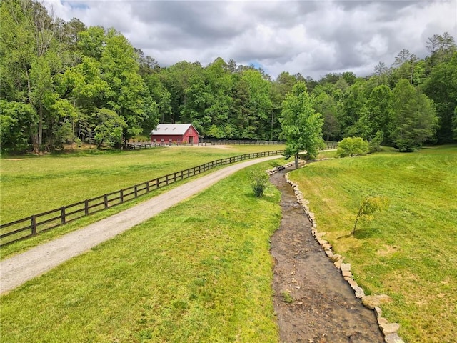 view of community featuring a yard and a rural view