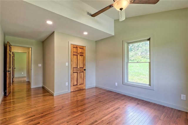 empty room featuring hardwood / wood-style floors and ceiling fan