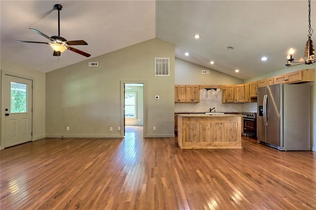 kitchen featuring a wealth of natural light, a center island, stainless steel appliances, and hardwood / wood-style flooring