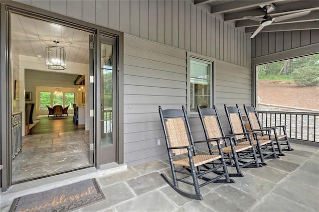 property entrance with covered porch and ceiling fan