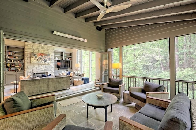 sunroom featuring beam ceiling, a wealth of natural light, and wooden ceiling