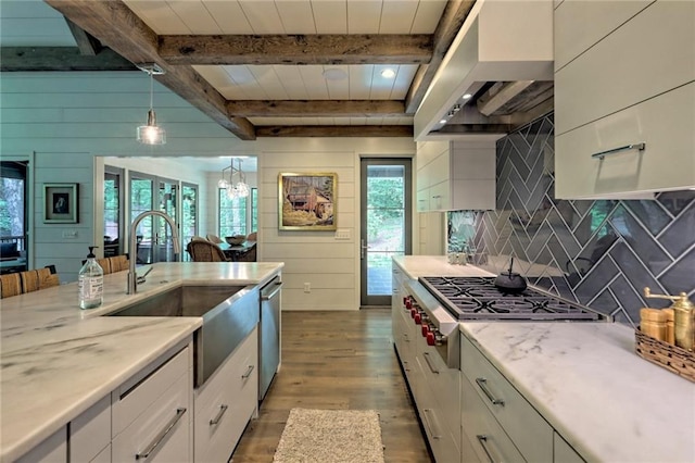 kitchen with beam ceiling, dark hardwood / wood-style floors, white cabinetry, and hanging light fixtures