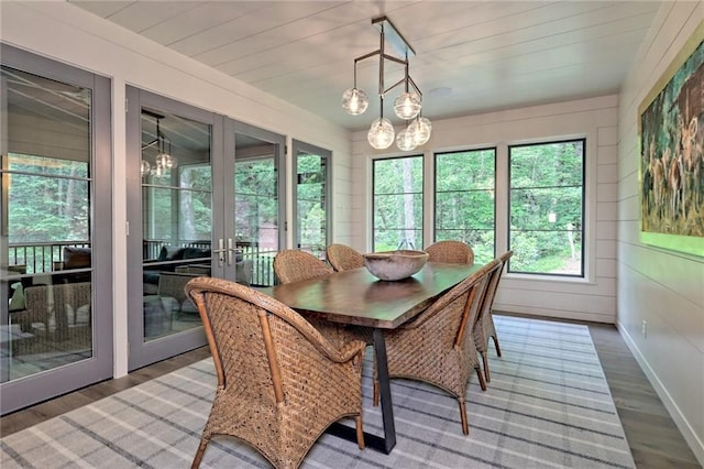 interior space with a notable chandelier and french doors