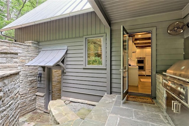 view of exterior entry featuring an outdoor kitchen