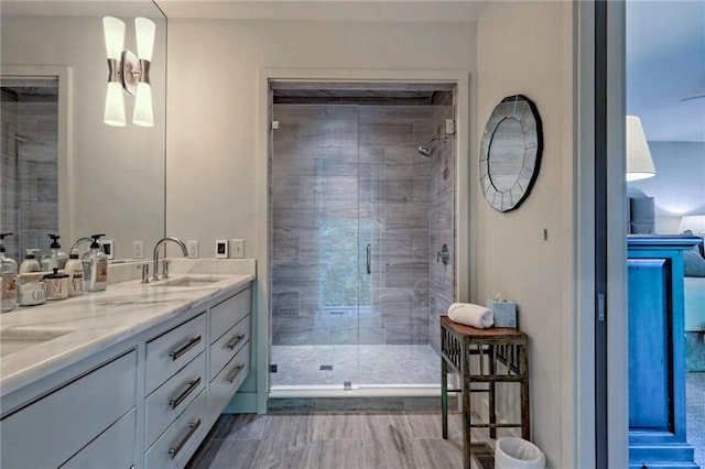 bathroom featuring vanity and an enclosed shower