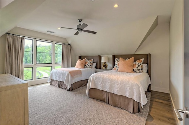 bedroom with hardwood / wood-style flooring, ceiling fan, lofted ceiling, and multiple windows