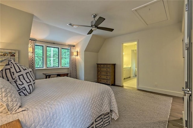 bedroom with ensuite bath, ceiling fan, wood-type flooring, and lofted ceiling