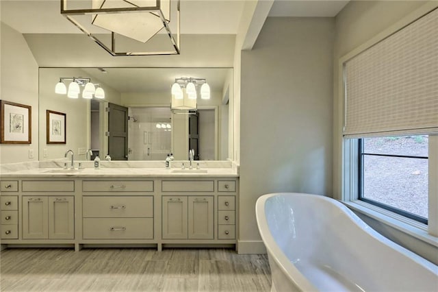 bathroom with hardwood / wood-style flooring, vanity, and shower with separate bathtub