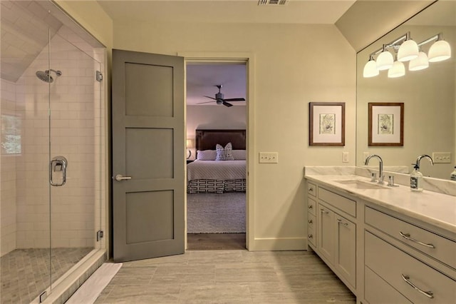 bathroom with ceiling fan, a shower with door, vanity, and vaulted ceiling