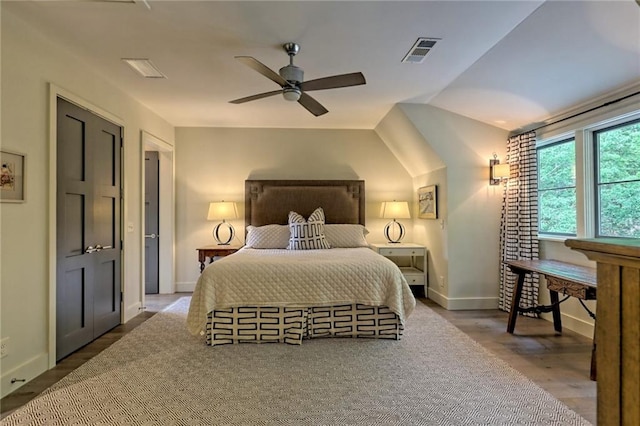 bedroom with ceiling fan and dark wood-type flooring