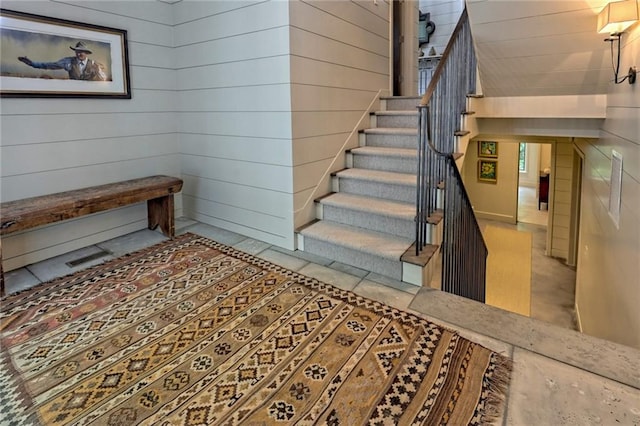 stairs with wood walls