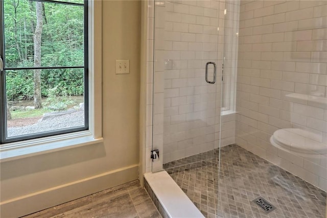 bathroom with a shower with door