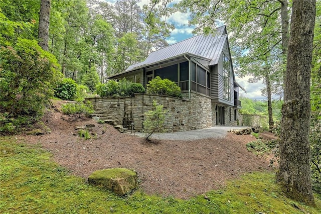 view of side of property featuring a sunroom