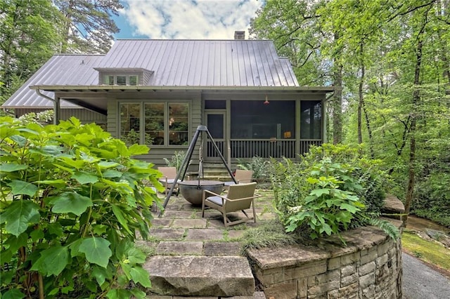 back of property featuring a sunroom