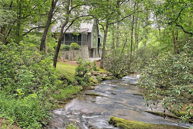 view of property exterior with a sunroom