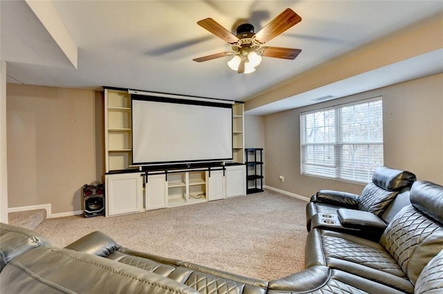 home theater featuring light carpet, visible vents, baseboards, and ceiling fan