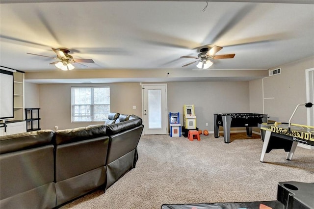 carpeted living room featuring visible vents, ceiling fan, and baseboards