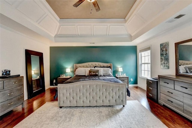 bedroom with coffered ceiling, visible vents, baseboards, ornamental molding, and dark wood-style floors