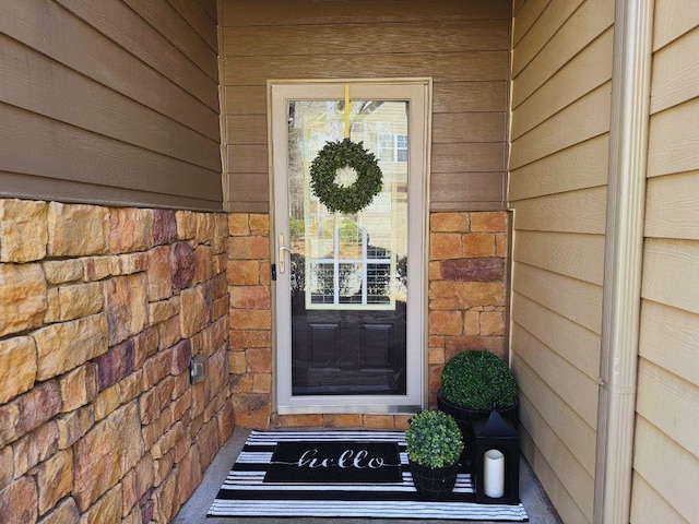 entrance to property featuring stone siding