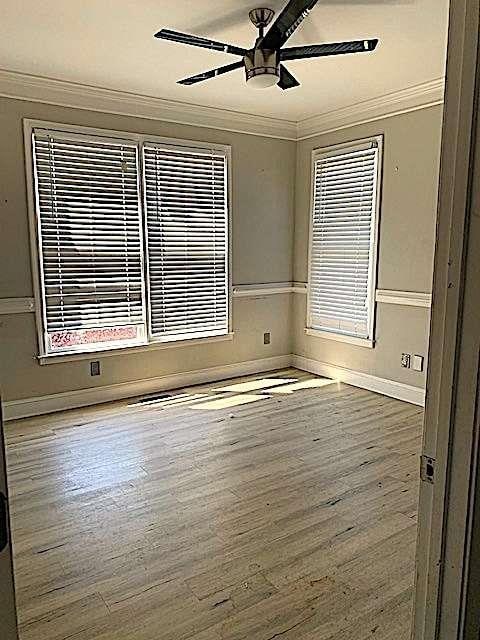 168 Harmony Grove Rd, Lilburn, GA 30047 - spare room with ornamental molding, a ceiling fan, wood finished floors, and baseboards