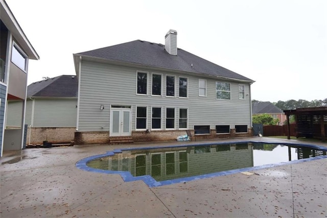 168 Harmony Grove Rd, Lilburn, GA 30047 - back of house featuring a patio area, a chimney, entry steps, and french doors