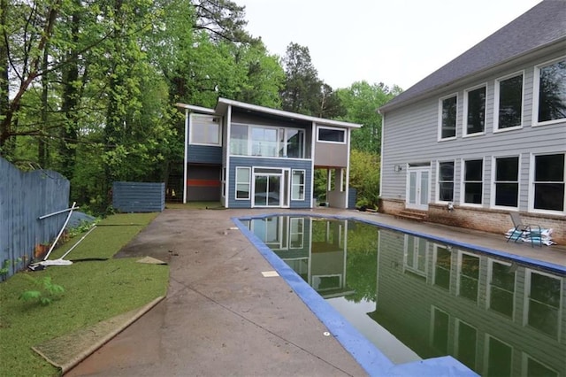168 Harmony Grove Rd, Lilburn, GA 30047 - view of swimming pool featuring a patio, french doors, and view of wooded area