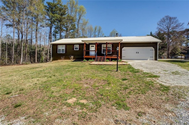 1240 H D Atha Rd, Monroe, GA 30655 - single story home with an attached garage, driveway, a front lawn, and covered porch