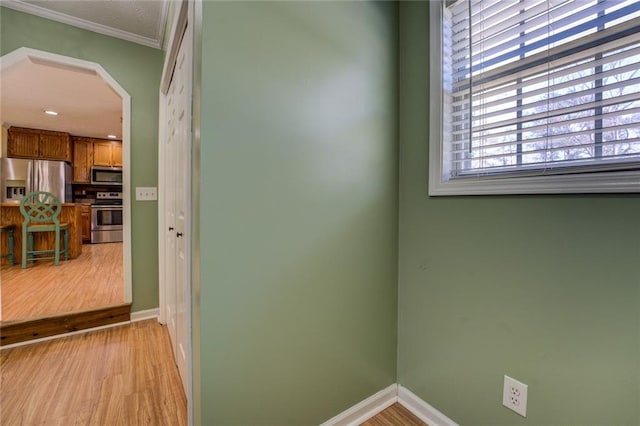 1240 H D Atha Rd, Monroe, GA 30655 - interior space with light wood-style flooring, baseboards, arched walkways, and crown molding