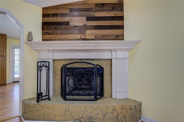 1240 H D Atha Rd, Monroe, GA 30655 - interior details featuring wood finished floors, a fireplace with raised hearth, baseboards, and ornamental molding