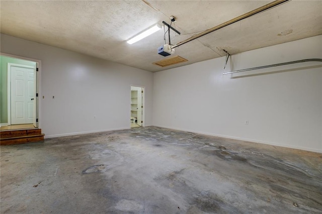 1240 H D Atha Rd, Monroe, GA 30655 - garage with baseboards and a garage door opener
