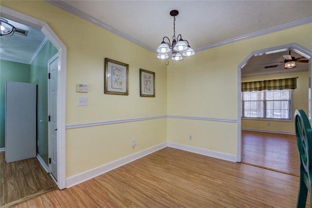 1240 H D Atha Rd, Monroe, GA 30655 - empty room featuring arched walkways, wood finished floors, crown molding, and baseboards