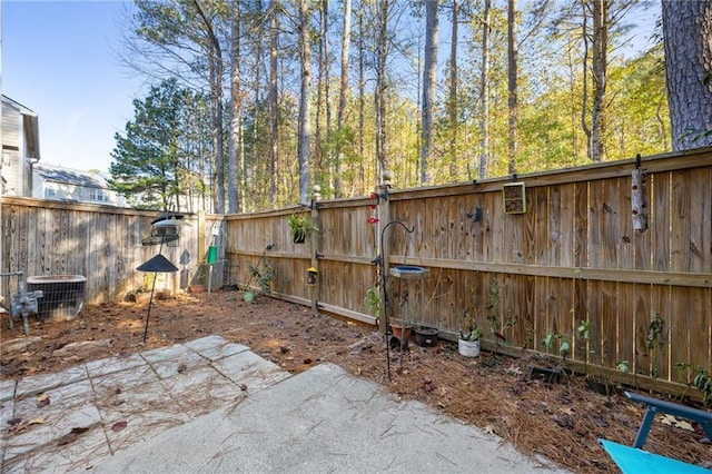 view of yard with a patio and central AC unit