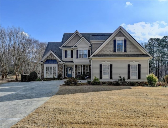 craftsman inspired home with a front lawn