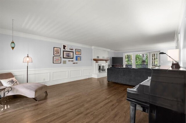 kitchen featuring stainless steel appliances, dark stone counters, a kitchen bar, white cabinets, and dark wood-type flooring