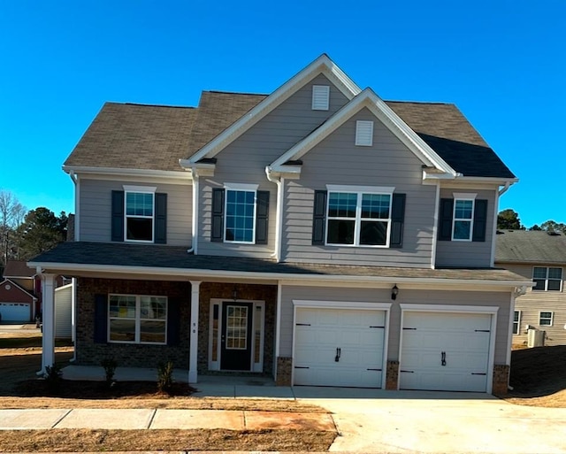 view of front of home featuring a porch and a garage