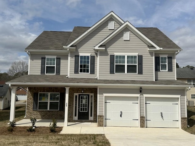 view of front of house with covered porch, driveway, brick siding, and an attached garage