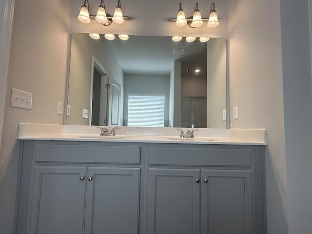 bathroom featuring double vanity, visible vents, and a sink