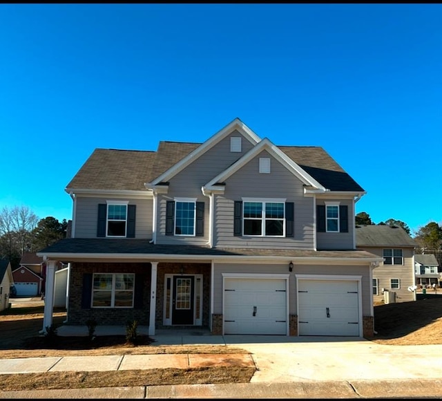 view of front of property featuring a porch and a garage