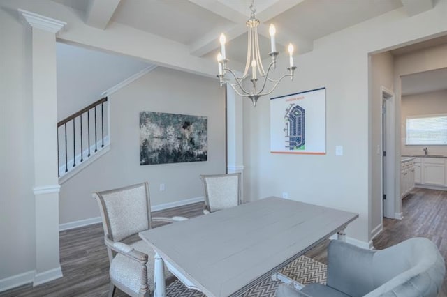 dining space with beamed ceiling, dark hardwood / wood-style flooring, an inviting chandelier, and sink